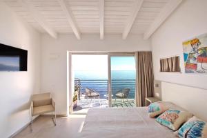a bedroom with a bed and a window at Hotel Caramare in Cala Gonone