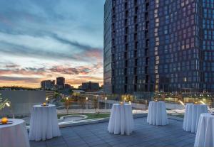 a row of tables on a rooftop with a city skyline at Hyatt Regency Tysons Corner Center in Tysons Corner