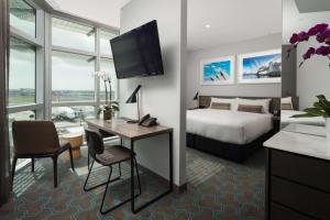 a hotel room with a bed and a tv at Rydges Sydney Airport Hotel in Sydney
