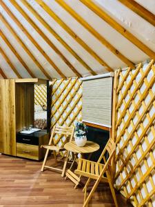 a room with two chairs and a table in a tent at The Glamping Spot Kalam in Kalām