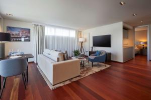 a living room with a couch and a table at Hyatt Regency Madrid Residences in Madrid
