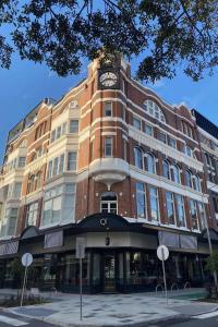 a large building with a clock tower on top of it at QT Newcastle in Newcastle