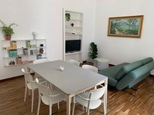 a living room with a table and a couch at Casa Margherita in Ostuni