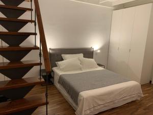 a bedroom with a bed and a staircase in it at Casa Margherita in Ostuni