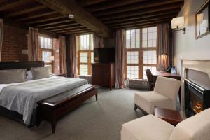 een hotelkamer met een bed en een open haard bij Martin's Klooster in Leuven