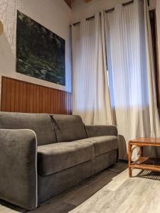 a living room with a couch and a table at La casetta nel bosco in Salò +15 photos