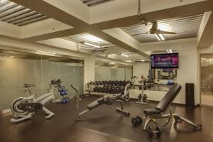 a gym with cardio equipment and a flat screen tv at The Madison Concourse Hotel in Madison