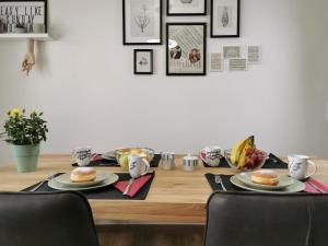 a dining room table with two plates of food on it at Neues City Center Piano Appartement mit Netflix in Klagenfurt