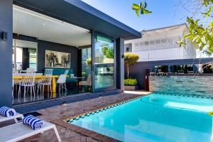 a swimming pool in the backyard of a home with a house at Life & Leisure Communal-Living in Stellenbosch