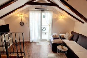 a living room with a couch and a large window at APARTMANI CENTAR VODICE in Vodice