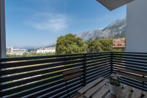 a bench on a balcony with a view of a mountain at Sea View Apartments Pezze in Makarska