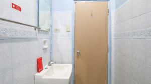 a bathroom with a sink and a mirror at RedDoorz Hostel @ Baguio Tourist Cabin in Baguio