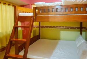 a pair of bunk beds with a ladder in a room at RedDoorz Hostel @ Baguio Tourist Cabin in Baguio
