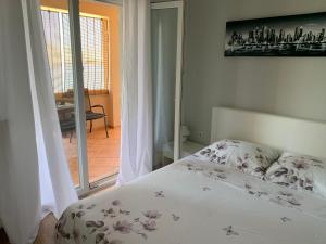 a bedroom with a bed and a view of a balcony at Apartman Demi in Miškovići