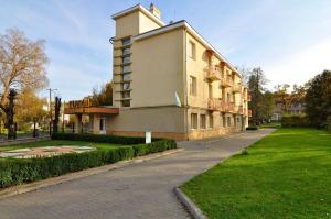 a large building on a street next to a park at Hotel Orion in Morshin