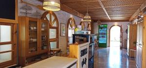 a kitchen with wooden cabinets and a counter in a room at Swiss Eviniz Hotel in Adrasan