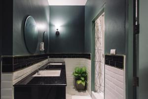 a bathroom with a sink and a mirror at Tongsiam in Chiang Rai