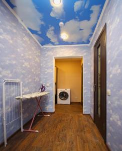 a room with a blue ceiling with clouds painted on it at FullHouse Hostel in Belgorod