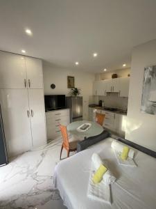 a bedroom with a bed and a table and a kitchen at Apartment Nikola in Matulji