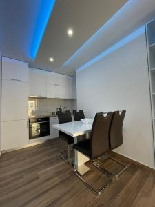 a dining room with a table and chairs in a kitchen at Coco apartments in Petrovac na Moru