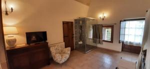 a living room with a shower and a television at Masseria Pagani in Nardò