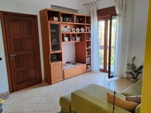 uma sala de estar com um sofá e uma estante de livros em Visitponza - Vesta em Ponza