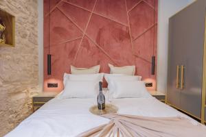 a bedroom with a white bed with a red wall at Heritage Rooms Split Olympic Dream in Split