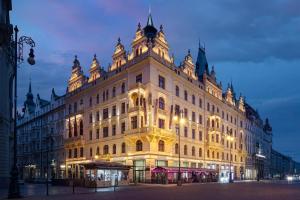 un gran edificio iluminado por la noche en Hotel KINGS COURT, en Praga