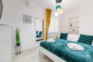 Posteľ alebo postele v izbe v ubytovaní Jantar Apartamenty Sobieskiego