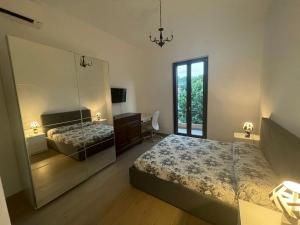 佩斯卡拉Casa Drema - Villa al mare con terrazza的有两张床和一面大镜子的卧室