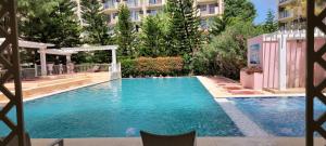 a large swimming pool with people in the water at Camella Northpoint Nottingham building unit 231 in Davao City