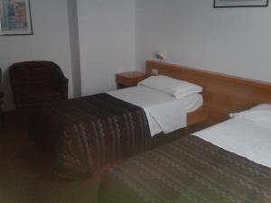 Postel nebo postele na pokoji v ubytování Hotel Niki