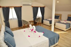 a hotel room with two beds and a mirror at Demyra Boutique Hotel in Demre