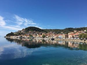 a large body of water with houses on a hill at North Evia Evanthia Greece in Kourkouloí