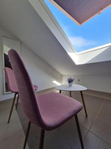 two purple chairs and a table in a room at Dream House Rajic in Trpanj