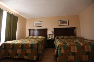 a hotel room with two beds and a window at Inn on the Gulf in Hudson