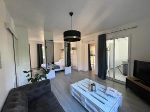 uma sala de estar com um sofá e uma televisão em Villa KIKO Spa & Sauna privatifs Gîte proche Sarlat em Vitrac