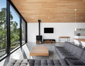 a living room with a couch and a fireplace at Luxurious Chalet with Pool, Sauna, Spa & Amazing View in La Malbaie