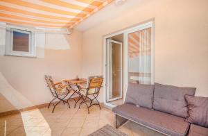 a living room with a couch and a table at Apartment Stella di Mare in Krk