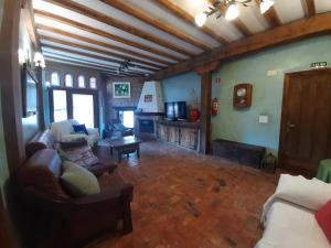 a living room with a couch and a tv at Neithea in Bóveda