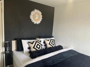 a bedroom with a bed with pillows and a mirror at Elite 47 Stays in Newcastle upon Tyne