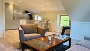 a living room with a couch and a coffee table at Oggevatn in Birkenes