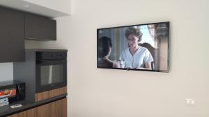 a television hanging on a wall in a kitchen at Piccolo paradiso in pieno centro Castel di Sangro in Castel di Sangro