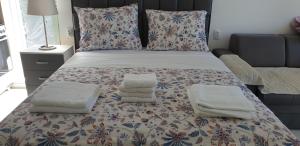 a bedroom with a bed with towels on it at Apartman studio BMB 2 in Veliko Gradište +19 photos