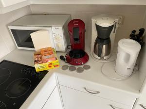 a kitchen counter with a coffee maker and a microwave at duinenveld in Nieuwpoort
