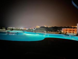 a swimming pool at night with blue lights at La Siesta Al Sokhna in Ain Sokhna