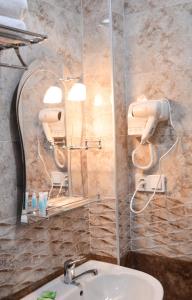 a bathroom with a sink and a mirror at Sea Line Hotel in Shekvetili