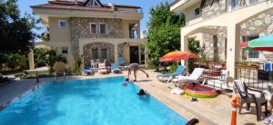 a person playing in a swimming pool in a house at çileks apart otel in Fethiye