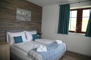 a bedroom with a bed with two towels on it at Penzion Königův mlýn in Loučná pod Klínovcem +36 photos