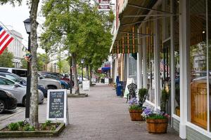 a street with a sign in front of a store at The Edenton Collection-Captain's Quarters Inn in Edenton